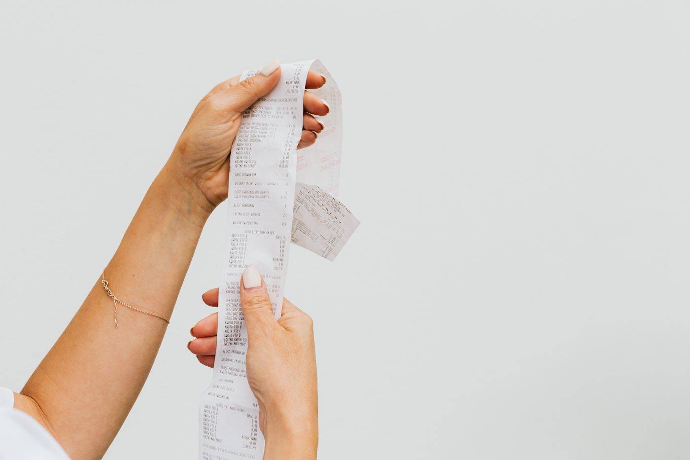 A long paper receipt held up for review